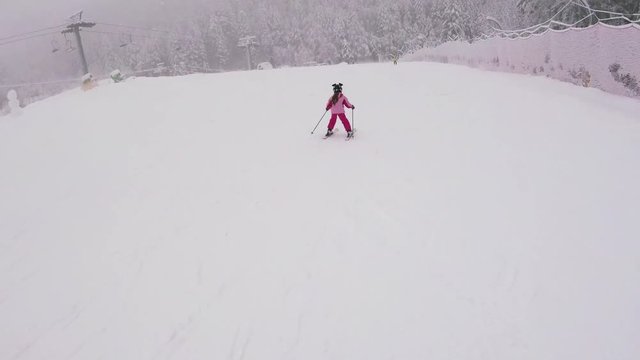 December 2017, Abetone, Italy - A little girl learning how to ski in mountains, gopro footage