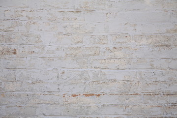 Old scratched white brick wall. Texture. 