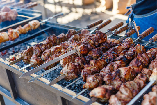 Grilling marinated shashlik on a grill. Shashlik is a form of Shish kebab  popular in Eastern, Central Europe and other places. Shashlyk meaning skewer  Stock Photo - Alamy