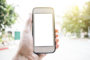 Young men use cell phones that leak the house at sunset.