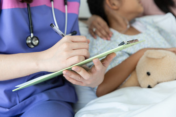 Doctor telling to patient kid and mother the results of her medical tests.