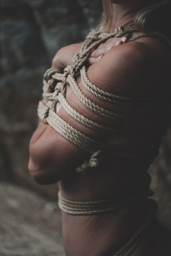 Woman bound with a rope in Japanese technique shibari
