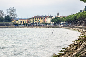 Turquoise waterfront of Lake Garda in town Peschiera del Garda. Peschiera del Garda is a town and commune in the province of Verona in Veneto, Italy.