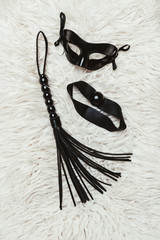 Black leather whip and ball gag with mask