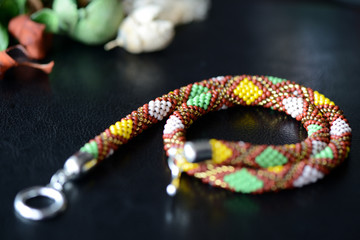 Ethnic style beaded necklace on a dark background close up