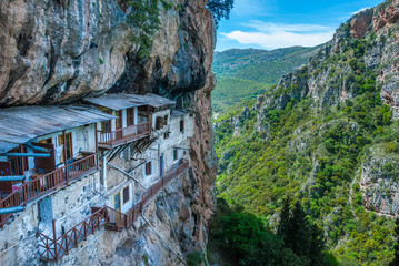 Prodromos monastery in Arcadia prefecture in Peloponnese Greece. The monastery is built in the 16th century on a huge vertical rock inside Lousios river gorge  - obrazy, fototapety, plakaty