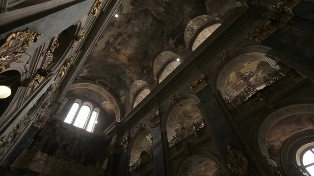 The architecture of old Gothic Church. The sun is breaking through the round windows on the roof.