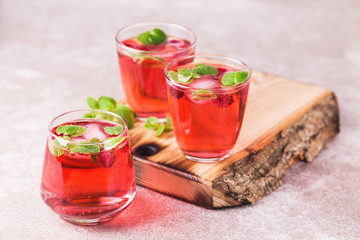 Aperitif with campari, mint and raspberry. Iced lemonade
