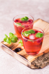 Aperitif with campari, mint and raspberry. Iced lemonade