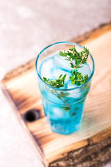 Ice Blue cocktail with thyme. Blue curacao liqueur. Summer