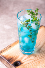 Ice Blue cocktail with thyme. Blue curacao liqueur. Summer