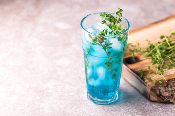 Ice Blue cocktail with thyme. Blue curacao liqueur. Summer