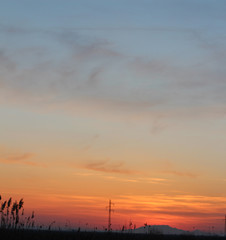 Sunset. The sun behind mountains. Scattered clouds and sky. The place for the text. Magnificent background. Excellent wall-paper. For designer. Suitable for texture.