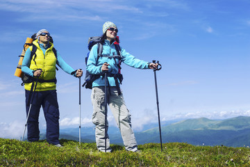 Summer hike in the mountains with a backpack and tent.