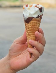 Hand Holding Ice Cream Cones with Chocolate