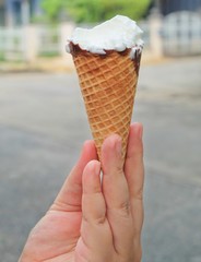 Hand Holding Ice Cream Cones with Chocolate
