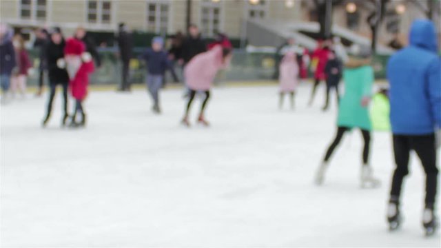 Winter skating rink was blurred,ice skating kids