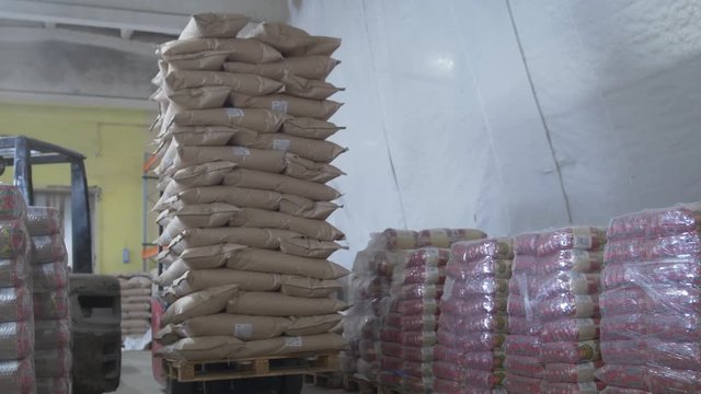 Working warehouse - loaders moves boxes on industrial