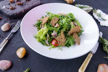fresh salad in beautiful composition on a concrete background