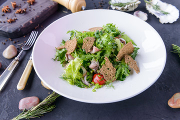 fresh salad in beautiful composition on a concrete background