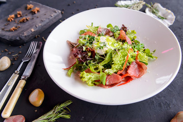 fresh salad in beautiful composition on a concrete background