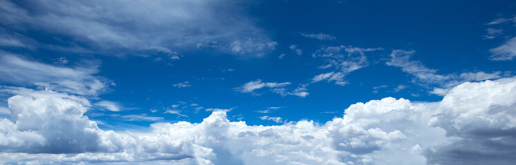Naklejka na ściany i meble Panorama of blue sky with white clouds