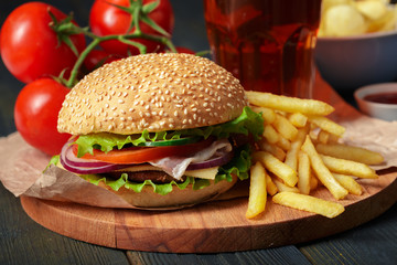 Fast food, homemade burger on a wooden background
