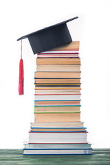 Graduation concept with stacked books and graduation hat