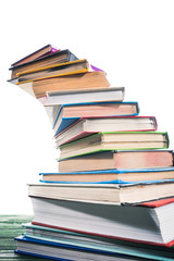 Curved stack of colorful books on table