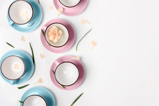 Blue and pink cups on white background