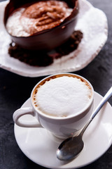 Tiramisu in a large chocolate egg on a concrete background