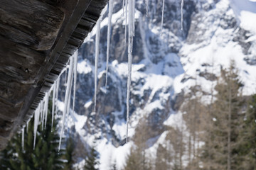icicles on a hut in the mountains