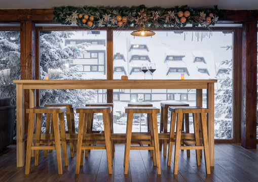 Bar and stools next to window on winter holiday