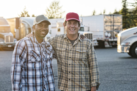 Truck driving team together in truck stop parking lot