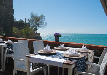 Table set on a panoramic terrace of a restaurant in Monterosso - 5 Terre - Genoa