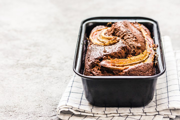 Delicious moist banana bread on light concrete background. Selective focus, space for text.