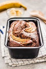 Cream cheese filled banana bread on light concrete background. Selective focus, space for text.