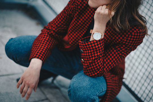 Outfit Details, Chic Woman Wearing A Stylish Red Pepita Houndstooth Pattern Jacket And A Rose Gold Watch. Detail Shot Of A Watch And Ring On A Womans Hand