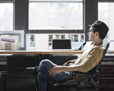 Man at his office workstation in creative office