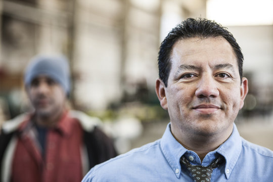 Hispanic man manager in a sheet metal factory.