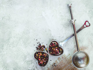 Metal tea infuser with leaves. Composition with tea accessories on a white background