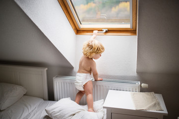 Toddler boy in a dangerous situation at home.