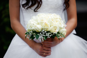 Beautiful bride holds wedding bouquet