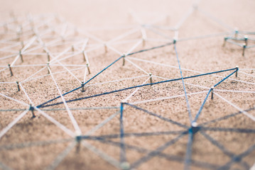 Linking entities. Network, networking, social media, connectivity, internet communication abstract. Web of threads on cork board.