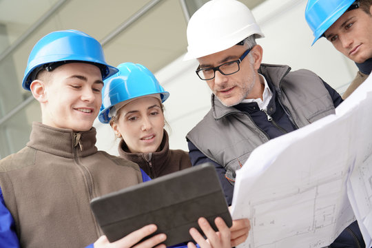 Instructor with young people in engineering training