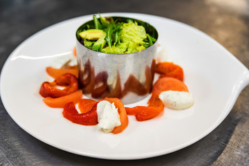Making salad on white plate at cooking workshop
