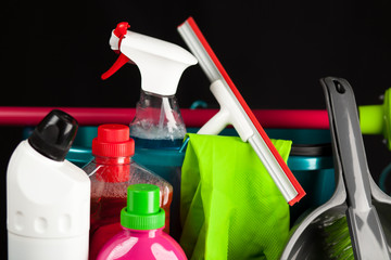Naklejka premium Cleaning supplies on black background