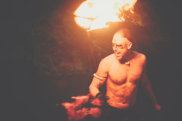 Awesome fire show at the waterfall. Brutal muscle man - Powered by Adobe