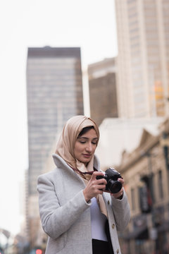 Woman in hijab looking at pictures