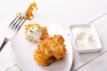 Potato pancakes with a slice on a fork